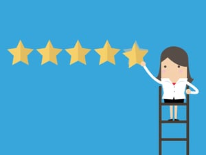 recruiter standing on ladder hanging five stars on a wall