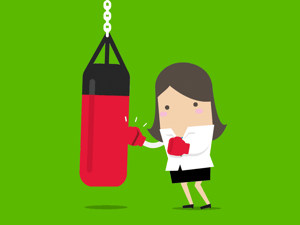 Woman hitting punching bag.